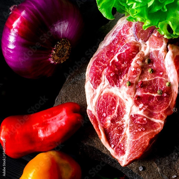 Obraz Two fresh raw ribeye steak on the stone on wooden background with salt, pepper
