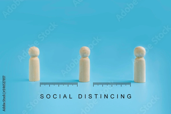 Fototapeta Wooden dolls on blue background with distancing and measure scale. people practice social distancing to protect from COVID-19 coronavirus spreading. Social distance preventing infection concept.