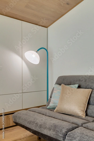 Fototapeta a modern room with a sofa and floor lamp