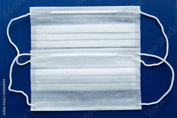 Fototapeta White masks on a dark blue background in the center.