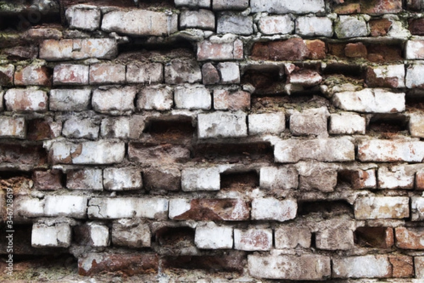 Fototapeta Old brickwork with fallen bricks.