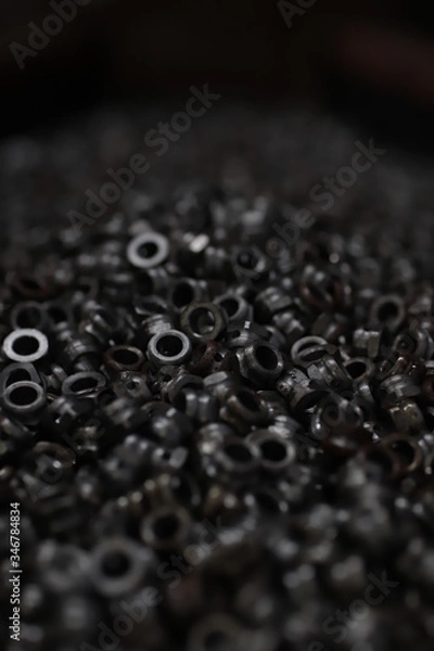 Fototapeta the raw material of the screw and machine producing bolts at the factory 