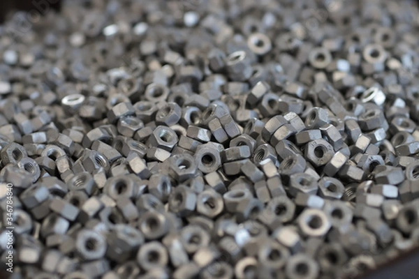 Fototapeta the raw material of the screw and machine producing bolts at the factory 