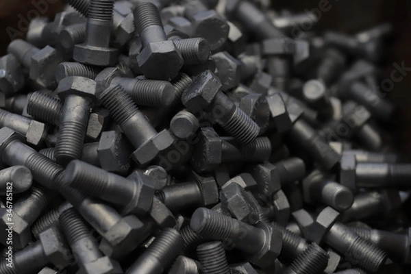 Obraz the raw material of the screw and machine producing bolts at the factory 