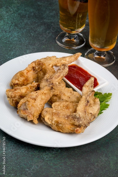 Fototapeta Chicken wings with sauce on a white plate
