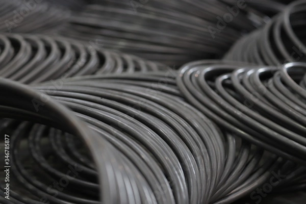 Fototapeta the raw material of the screw and machine producing bolts at the factory 