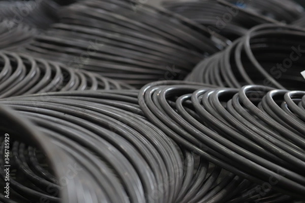 Fototapeta the raw material of the screw and machine producing bolts at the factory 