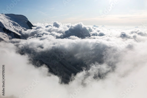 Fototapeta Clouds and fog over the Chamonix valley. View from the Cosmique refuge, Chamonix, France. Perfect moment in alpine highlands.