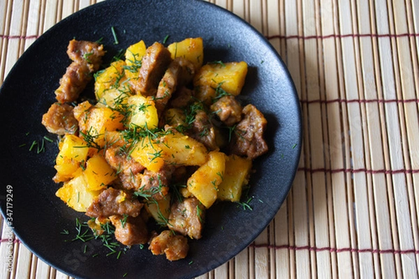 Fototapeta Fragrant roast with potatoes in the oven