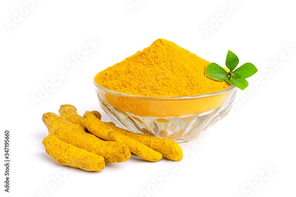 Fototapeta Turmeric powder in glass bowl with green leaves and dry roots isolated on white background.