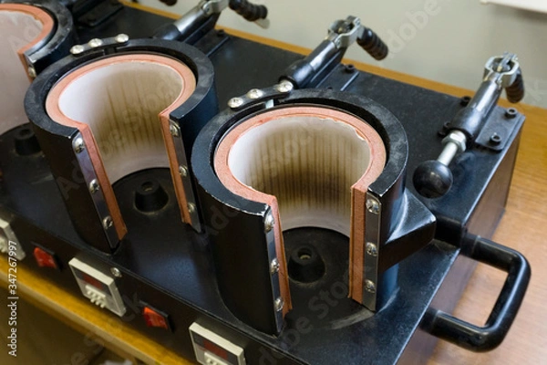 Obraz Sublimation mug production. Thermopress for mugs on several cells. Equipment for the manufacture of souvenirs.