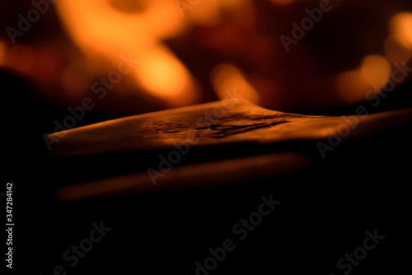Obraz close up of an axe in front of a bonfire 