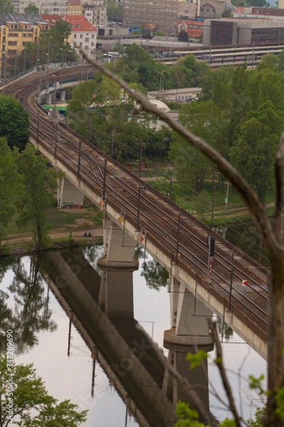 Fototapeta 
railway bridge in Prague over the Vltava river in the spring of 2020 in the Czech Republic. reflections can be seen on the surface