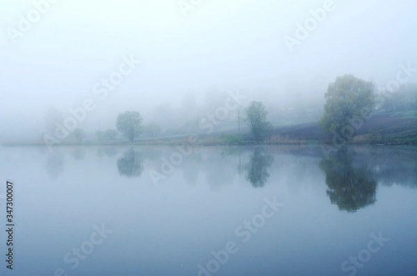 Fototapeta Fog on the lake, cloudy morning, poor visibility and high humidity.