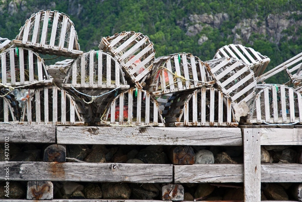 Fototapeta Collection of lobster pots on a jetty