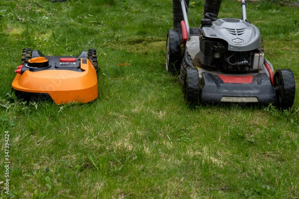 Fototapeta Big old and new small robot lawn mowers in the work