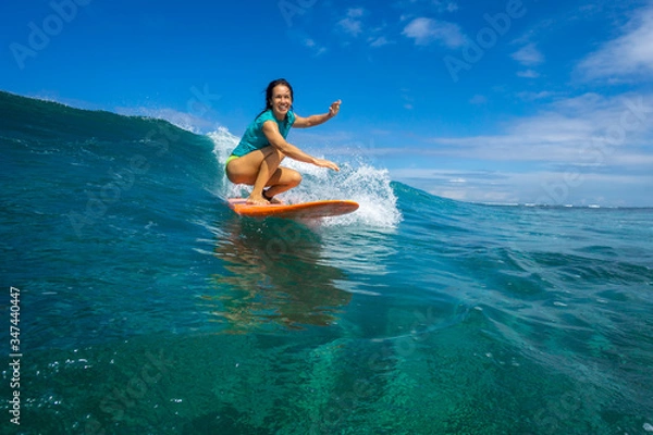 Obraz beautiful girl surfing on big transparent waves