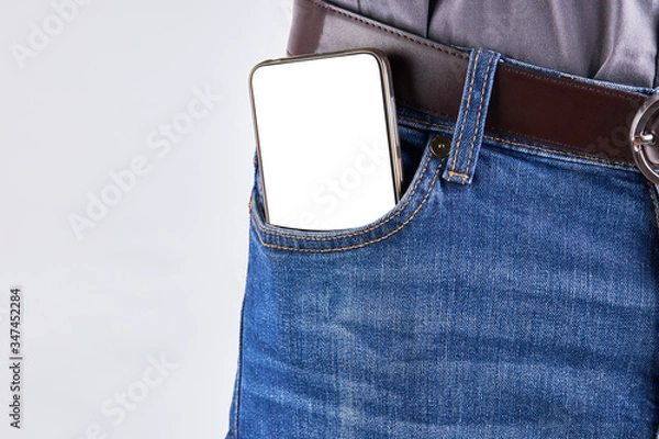 Fototapeta male person with a phone  at front jeans pocket. empty display mockup.