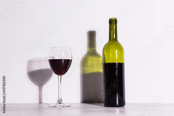 Fototapeta Shadow of wine glass in dark light.