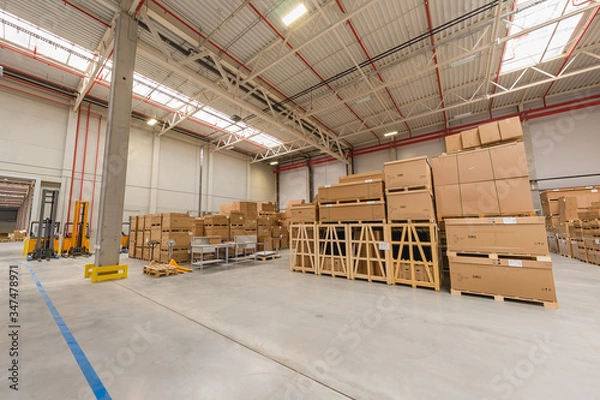 Fototapeta warehouse loading cardboard boxes by forklift stacker loader