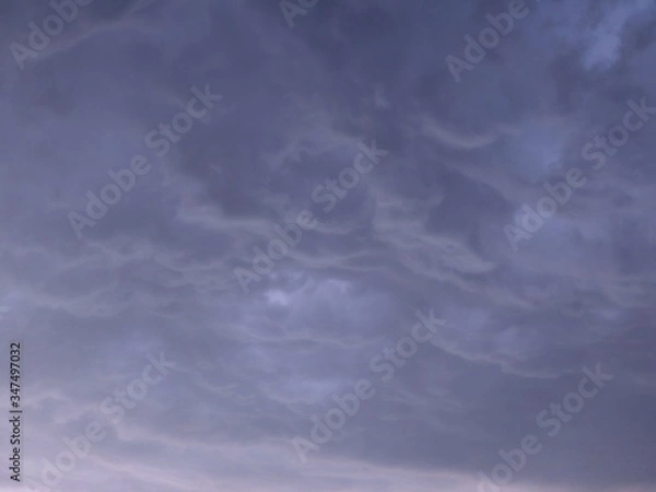 Obraz Blue background with heavy thunder clouds in the sky, space for text