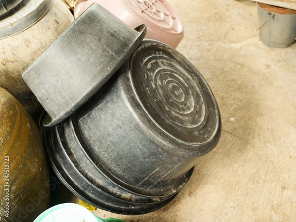 Obraz Black plastic basin that is stacked upside down.