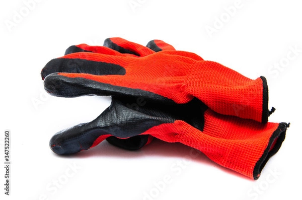 Fototapeta Gloves for workers, construction red with black rubber coating. Black-red gloves. Gloves on a white background, palm up, down. Glove on  glove
