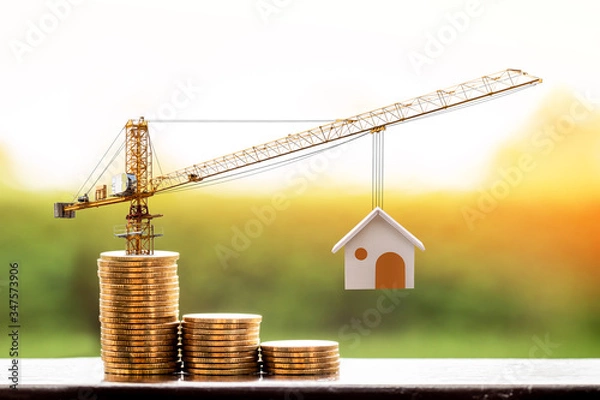 Obraz Stacking gold coins with increase and tower crane and hoist brake solutions with build new house in the public park, saving money and loan for construction real estate and home concept.