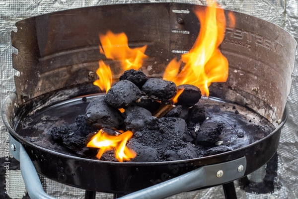 Obraz Lighting a charcoal grill. Flames.