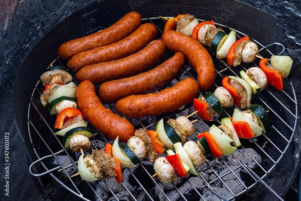 Fototapeta Summer Grill. Grilled sausage and skewers.