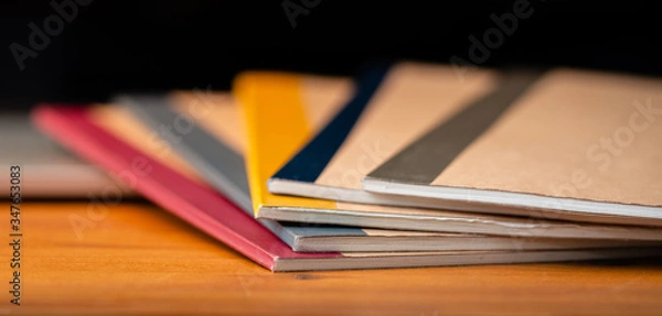 Fototapeta Close Up of Several Notebooks with Unfocused Background.