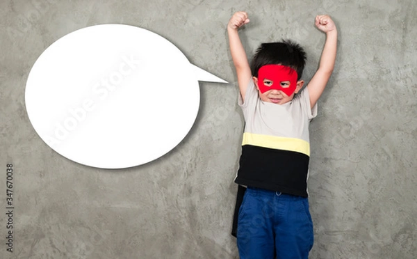 Obraz The boy in the superhero outfit smiled with his hands showing his strength, with a popup for the message beside him..Study the concepts and development of young children.