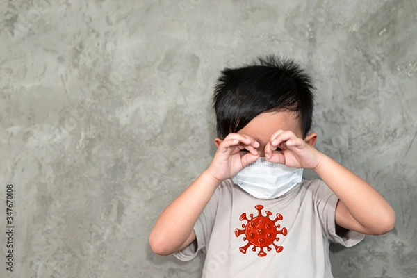 Obraz A boy wearing medical face mask for pollution or coronavirus,child itchy eyes and nose, Kid scratching nose while wearing protection mask.Protection against contagious disease, coronavirus.