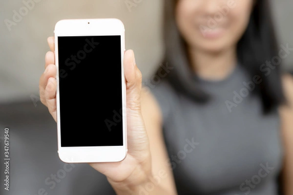 Obraz Women was show smart phones. The mobile has a black space for your pictures and text, destination technology and people concept.
