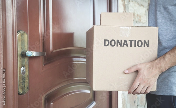 Fototapeta Caucasian volunteer with Donation box.