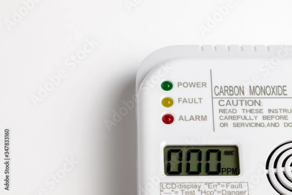 Fototapeta Carbon monoxide detector on a white wall. Stay home safe. Home control and security.  CO detector