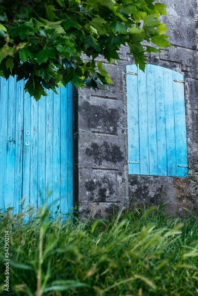 Fototapeta Blue door and window on a stone wall