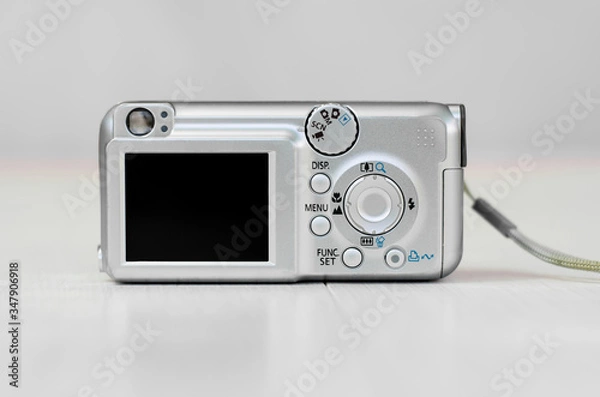 Obraz Old camera on a light background. Close-up camera. Back view.