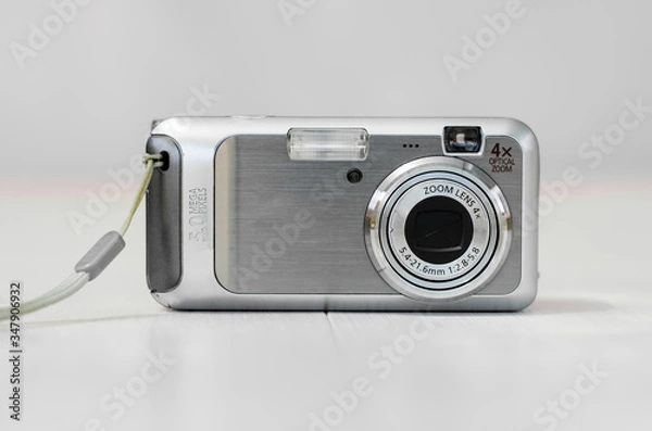 Fototapeta Old camera on a light background. Close-up camera. Front view.