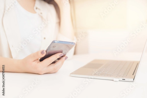 Fototapeta Young woman after being fired work is looking for online jobs on Internet through laptop. Concept effects of pandemic, unemployment