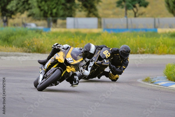 Obraz Motorcycle practice leaning into a fast corner on track