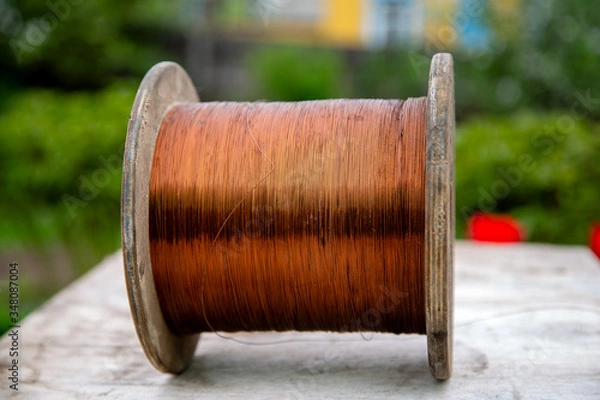 Fototapeta wooden cable reel with wound copper wire
