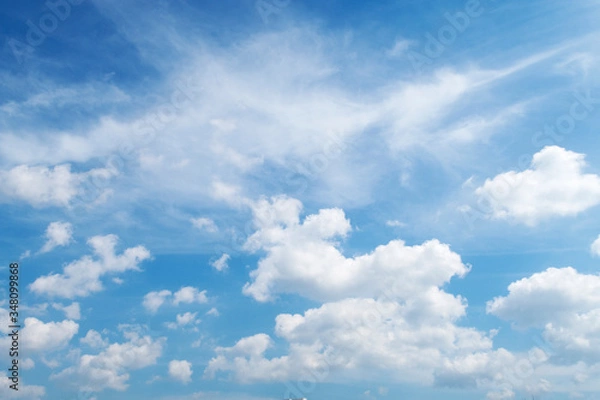Obraz Natural sunny blue sky background with beautiful puffy white cumulus clouds & fluffy cirrus cloudscape on bright daylight horizon in tropical summer sunlight & exotic sun ray at sunny & sunshine day