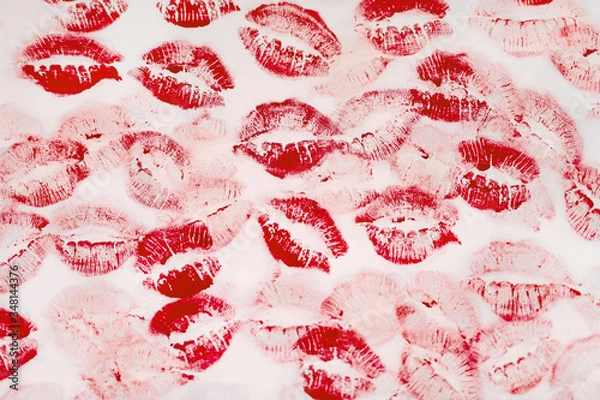 Obraz A lot of kissing marks made with the red lipstick on the white paper background - Image. Paper with lipstick kisses. Abstract passion love background.  Imprints of female lips. 