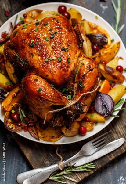 Obraz Roast whole chicken with roast vegetables on plate on a table