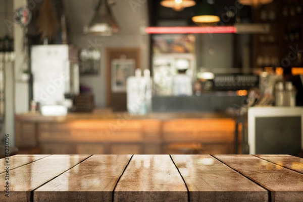 Fototapeta Empty old wood table top with bokeh coffee shop interior background.