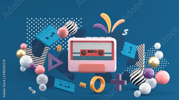 Fototapeta The tape player is surrounded by colorful tape and balls on a blue background.-3d rendering..