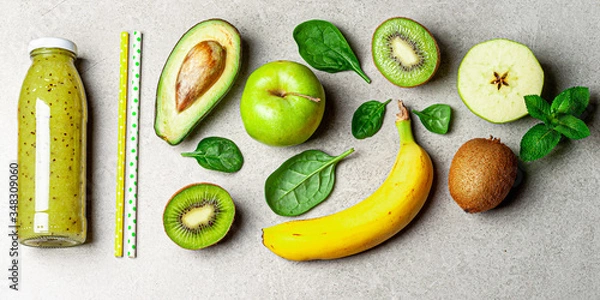 Fototapeta Kiwi fruits smoothie and ingredients on table. Kiwi green smoothie with banana, avocado, apple, spinach, chia seeds. Healthy summer drink. Diet, superfoods, detox, healthy food, vegetarian concept