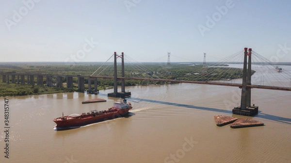 Obraz Long Arm Zarate Bridge, located in South America, Argentina, divides the province of Buenos Aires and Entre Rios. below this ship, cargo ships to Brazil and other destinations.