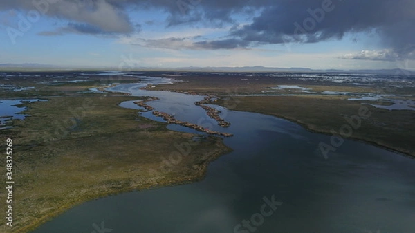 Fototapeta Lake Titicaca in Puno in Peru, view from drone and floating islands of the Uros people in the background